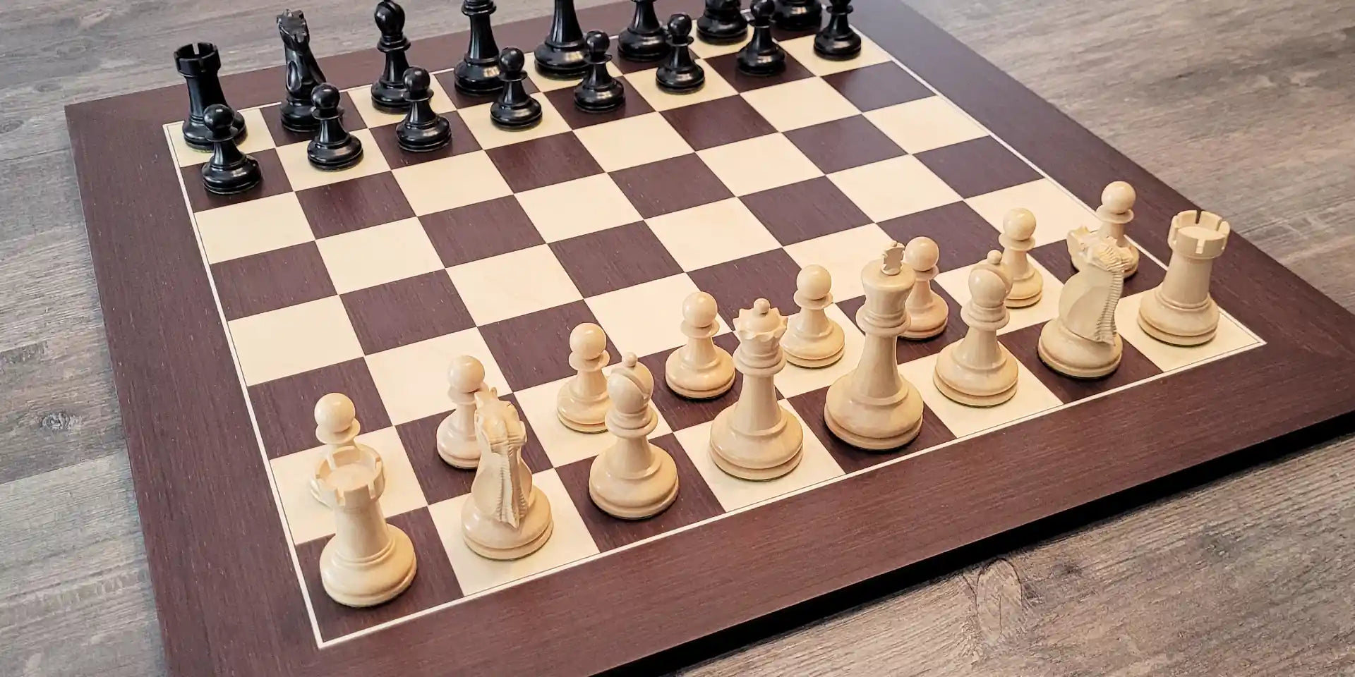Wenge chess board with chess pieces on it